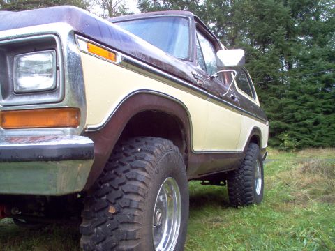 1979 Ford Bronco - This two-tone Ford Bronco, likely a 1978 model, is shown from a low angle with large off-road tires.