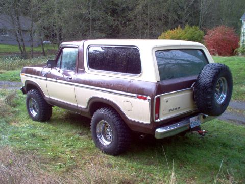 1979 Ford Bronco - This 1979 Ford Bronco features a distinctive two-tone brown and cream paint scheme and a rear-mounted spare tire.