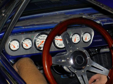 1965 Ford Mustang - Custom gauges and a wood-rimmed steering wheel are visible inside this 1965 Ford Mustang.