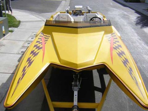 1991 Ford Bronco - A yellow boat with racing graphics is displayed on a trailer.