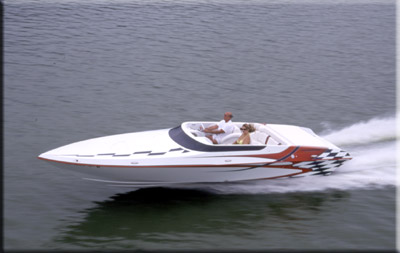1991 Ford Bronco - A white and red speedboat with a checkered flag design on the stern speeds across the water with two occupants.