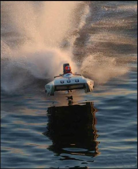 1991 Ford Bronco - A powerboat with the number 88-B on its side cuts through the water, leaving a trail of spray.