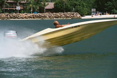 1991 Ford Bronco - A yellow boat with a Yamaha outboard motor speeds across the water, kicking up a large spray.