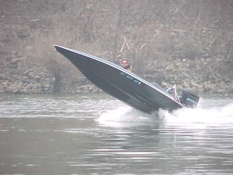 1991 Ford Bronco - A boat speeds across the water with a person steering.
