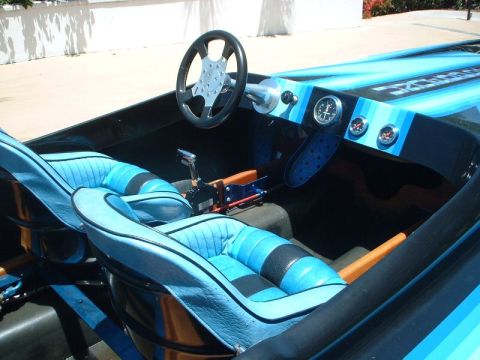 1991 Ford Bronco - The interior of a boat shows two bucket seats, a steering wheel, and dashboard gauges.