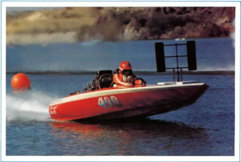 1991 Ford Bronco - A driver navigates a red and white racing boat numbered 400 through the water.