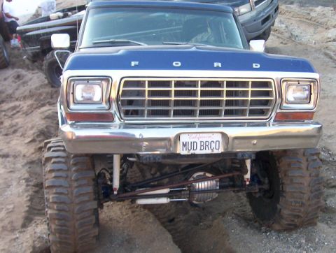 2000 Ford F-450 - This lifted Ford pickup truck has a prominent grille and large off-road tires.