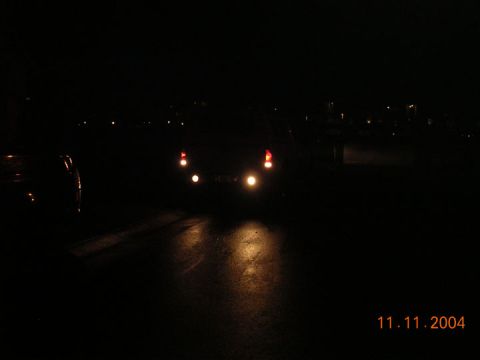 2004 Ford F-250 - The rear lights of a vehicle are illuminated at night, with the date 11.11.2004 visible in the lower right corner.