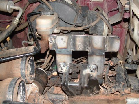 1990 Ford Bronco - Custom dual battery mount installed in the engine bay, showing fabricated metalwork and wiring.