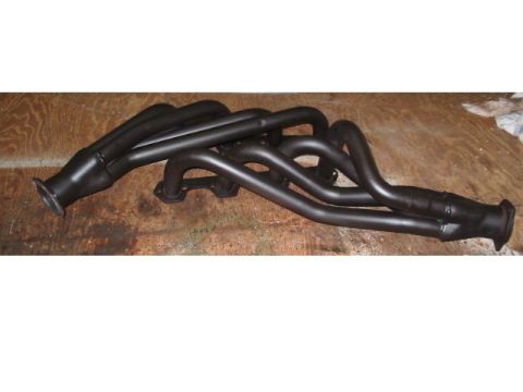 1985 Ford Crown Victoria LTD - Black exhaust headers are shown on a wooden surface, likely for an automotive application.