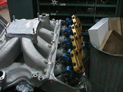 1979 Ford Bronco - Engine intake manifold and valve train parts are visible in this workshop setting.