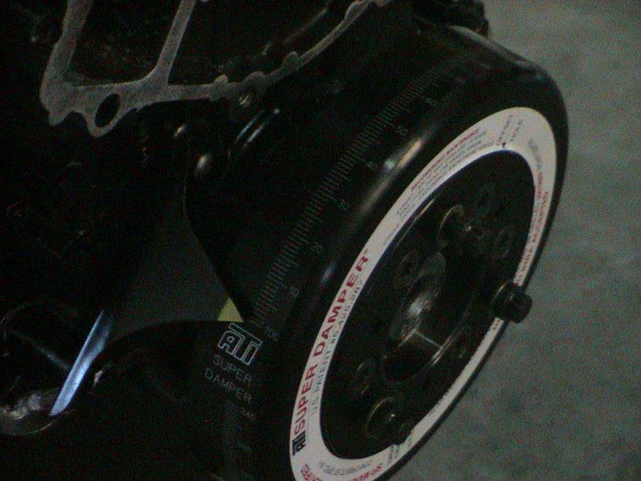 Black ATI Super Damper with white markings and degree scale