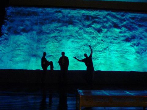 1996 Ford Probe - Silhouettes of people are visible against a vibrant, textured background illuminated with blue and green light.