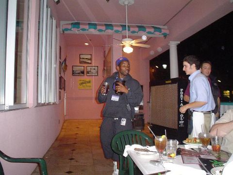 1996 Ford Probe - People gather at an outdoor dining area with pink walls and a ceiling fan.