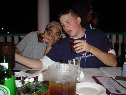 1996 Ford Probe - Two men enjoy drinks at an outdoor table at night, with a bottle of beer in the foreground.