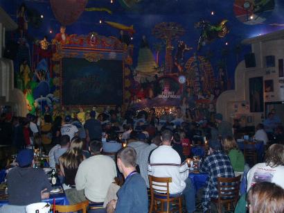1996 Ford Probe - A busy restaurant scene with people dining under a vibrant, detailed mural.