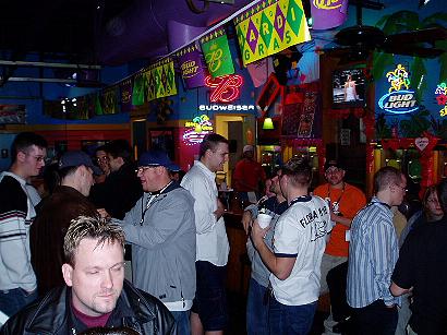 1996 Ford Probe - A crowded bar scene with Mardi Gras decorations and neon signs is visible.