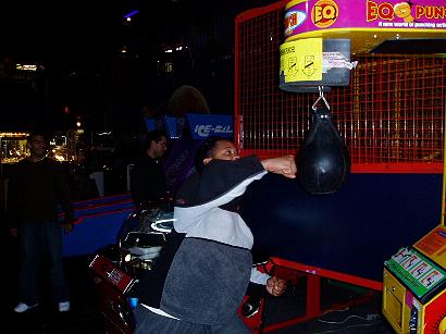 1996 Ford Probe - A person plays a punching bag arcade game in a dimly lit entertainment venue.