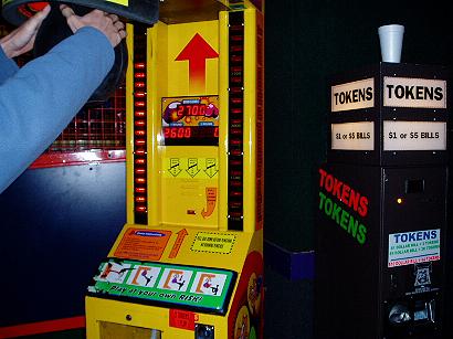 1996 Ford Probe - A yellow arcade game with a digital score display and a token dispenser is visible in the frame.