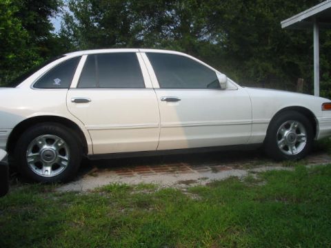 1997 Ford Crown Victoria - Side view of a white 1997 Ford Crown Victoria with tinted windows.