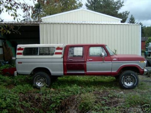 1981 Ford Bronco - This pickup truck features a two-tone paint scheme and a camper shell with red stripes on the windows.