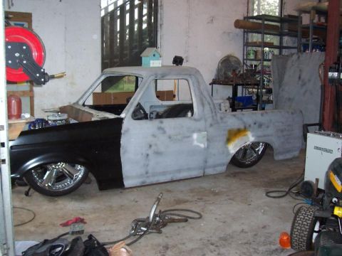 1985 Ford Bronco - A truck body is undergoing repairs and customization in a workshop environment.