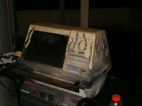 1996 Ford Bronco - A grill with flame decals is shown in a dimly lit outdoor setting.