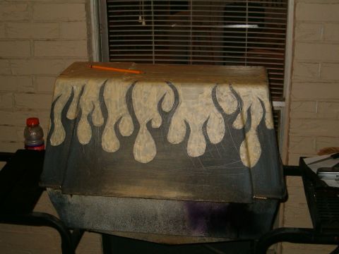 1996 Ford Bronco - A car cover with a custom flame paint job is shown, resting on an outdoor table.