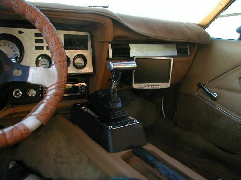 1978 Ford Mustang II - The interior of a 1978 Ford Mustang II shows its brown dashboard, steering wheel, and center console.