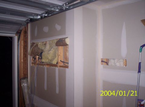 1986 Ford Bronco - This image shows a room undergoing construction, with exposed framing and insulation visible through openings in the drywall.