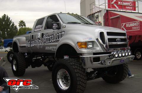 1993 Ford Bronco - This heavily modified Ford F-650 truck features custom graphics and is displayed at an event.