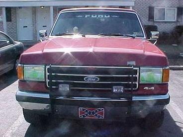 1990 Ford Bronco - Front view of a red 1990 Ford Bronco parked in a lot.