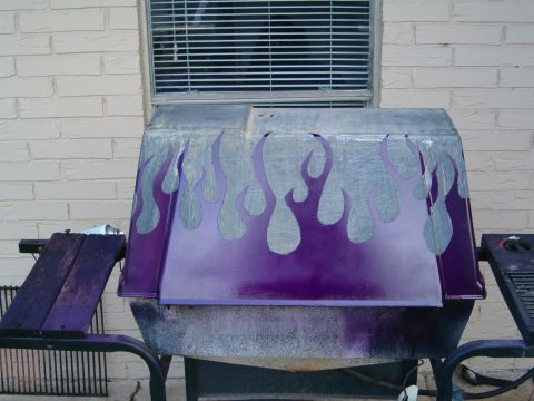 1996 Ford Bronco - A car hood with custom flame paint is displayed outdoors.