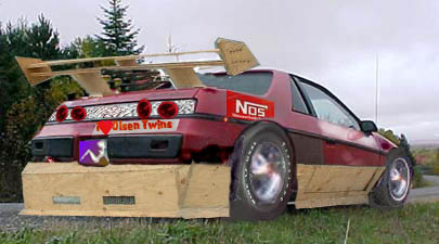 1986 Pontiac Fiero - This heavily modified 1986 Pontiac Fiero features a custom wooden body kit and a large, multi-tiered spoiler.