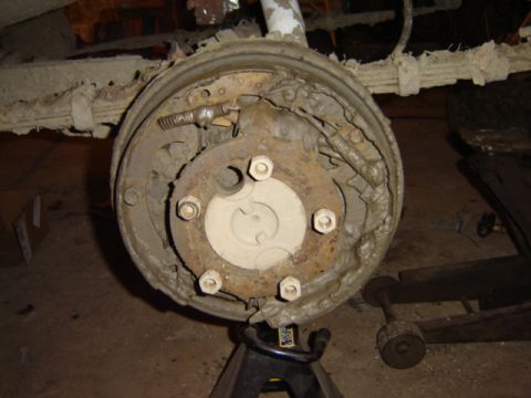 1992 Ford Bronco - Close-up view of a rear drum brake assembly, likely undergoing maintenance or repair.