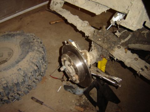 1992 Ford Bronco - Close-up view of a vehicle's undercarriage, showing a tire and suspension components.