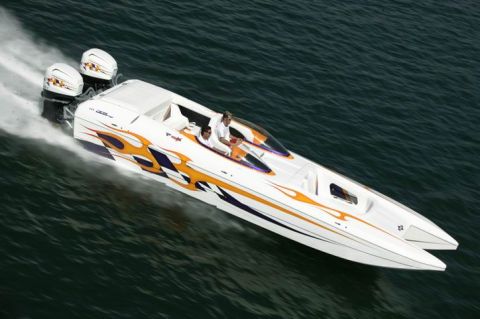 1991 Ford Bronco - Performance boat with twin outboard engines speeds across the water, displaying flame graphics.