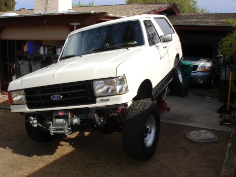 1987 Ford Bronco - This 1987 Ford Bronco is shown on a lift, highlighting its suspension and front winch.