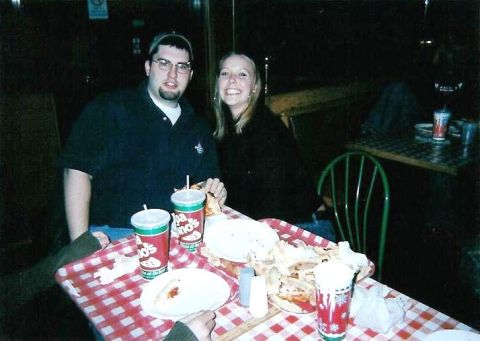 1998 Ford Taurus - A couple poses for a photo while seated at a table covered with a red and white checkered cloth.