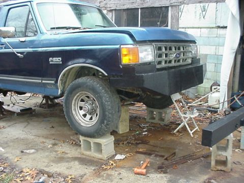 1988 Ford Bronco - Front view of a Ford F-series truck, likely from the late 1980s, undergoing repairs.
