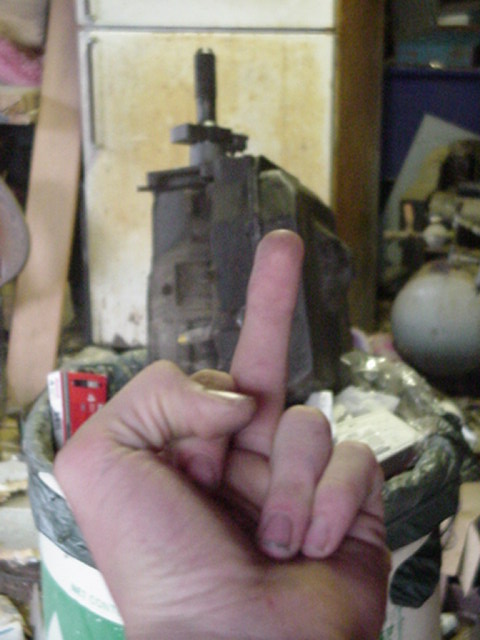 1988 Ford Bronco - A hand is shown giving the middle finger in front of a blurry mechanical object.