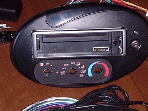 1998 Ford Taurus - A car's radio and climate control panel is shown, with wiring visible.