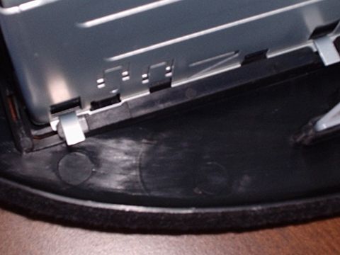 1998 Ford Taurus - Close-up of a car radio mounting bracket, showing metal clips securing it in place.