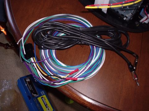 1998 Ford Taurus - A bundle of colorful wires and an antenna adapter are laid out, with a JVC stereo box nearby.