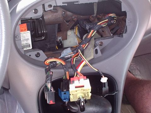1998 Ford Taurus - Close-up view of the vehicle's interior wiring harness and ignition switch assembly.