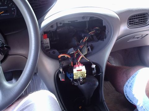 1998 Ford Taurus - Interior view of a 1998 Ford Taurus with the radio assembly removed, revealing wiring.