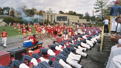 1978 Ford Bronco - A football team practices on the field while another group performs push-ups in the foreground.