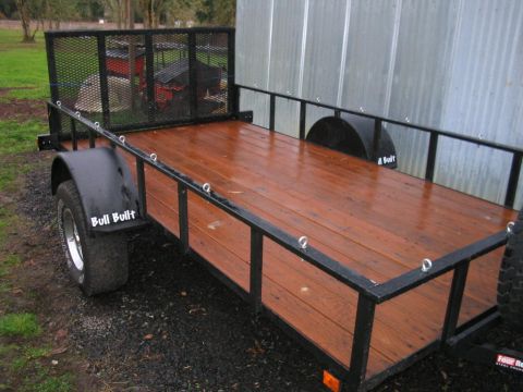 1991 Ford Bronco - This utility trailer features a wooden deck and metal side railings, with 'Bull Built' branding visible on the fender.