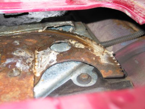 1995 Ford Bronco - This image shows a heavily rusted metal part with a serrated edge, likely a component from a vehicle's mechanical system.