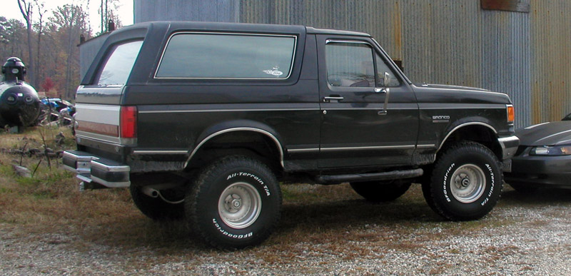 Black Ford Bronco SUV parked outdoors, side view. BFGoodrich All-Terrain T/A tires